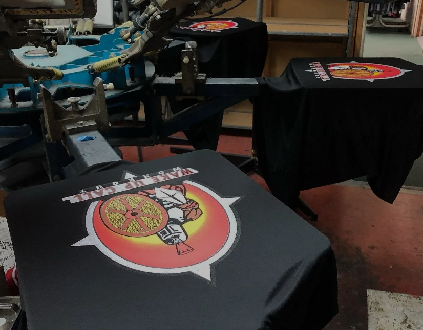 A T-shirt with a Logo on it is Being Printed on a Machine, Soquel, CA, Sport About Graphics